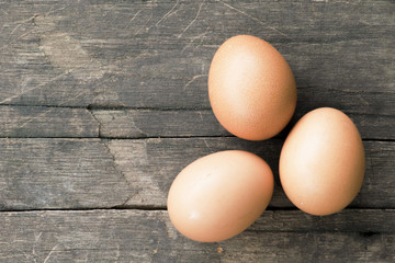Eggs on wooden table background. Top view.