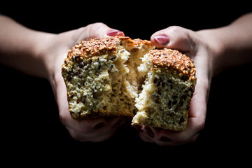 Rustic loaf of bread in the woman hands