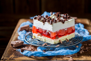 Tasty cake with jelly, chocolate chips and fruits