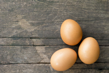 Eggs on wooden table background. Top view.