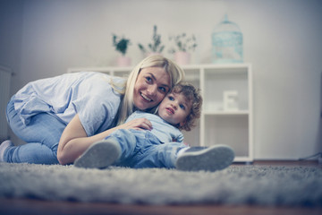 Fototapeta premium Mother and son have enjoy together in their living room.
