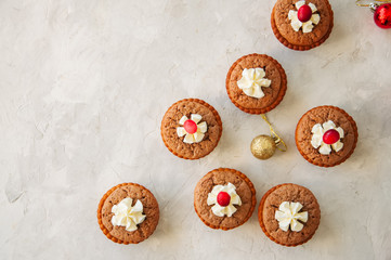 Brownie mins pies with cranberries on a white stone background