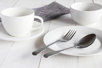 Design concept of mockup various kitchenware utensils set on white wooden table.