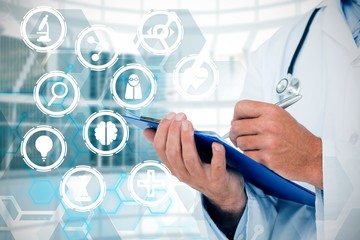 Composite image of doctor writing on clipboard