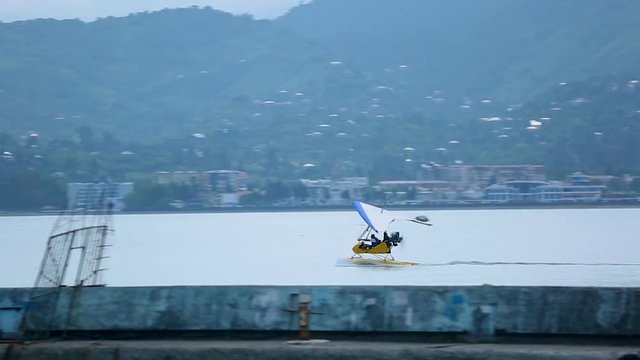 Deltaplane taking off from sea surface, adrenaline and speed, bright impressions
