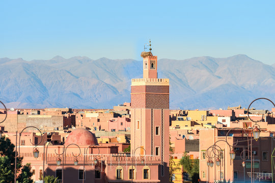 panoramic views of marrakech medina with atlas mountain at background, morocoo