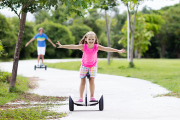 Naklejka premium Child on hover board. Kids riding scooter