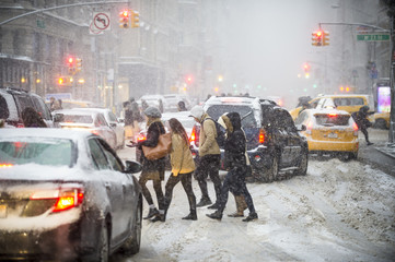 Pedestrians trying to cross a traffic jam when a  winter snowstorm brings chaos to Midtown...