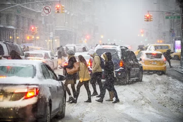 Zelfklevend Fotobehang Pedestrians trying to cross a traffic jam when a  winter snowstorm brings chaos to Midtown Manhattan, New York City © lazyllama