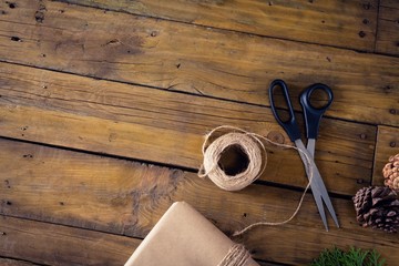 Fir, pine cone and wrapping materials on wooden table
