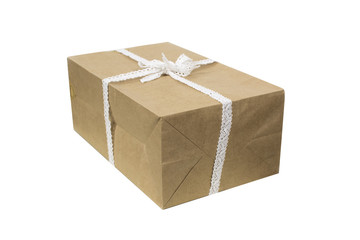 Kraft gift box, with a white lace bow on the top isolated on white background