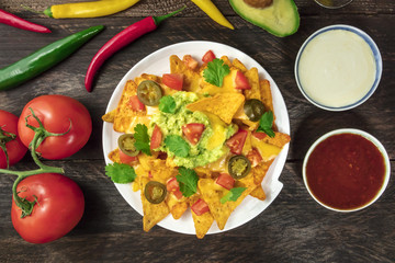 Nachos with cheese, traditional Mexican snack, with ingredients
