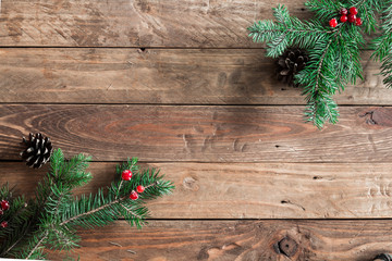 
A wooden background with sprigs of fir cones and cranberries. Christmas background. - 183930899