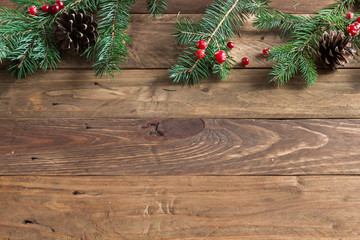 
A wooden background with sprigs of fir cones and cranberries. Christmas background. - 183931028