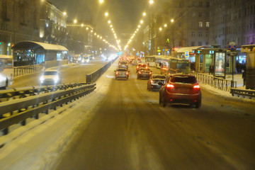 snowy road night city