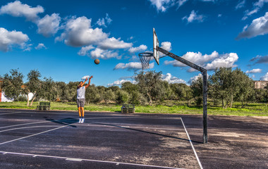 Fototapeta na wymiar Lefty basketball player practicing jump shot