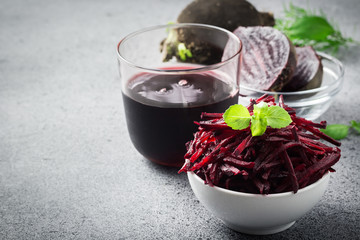 Beetroot detox juice and sliced beetroot in a bowl. Selective focus, copy space, close up. 