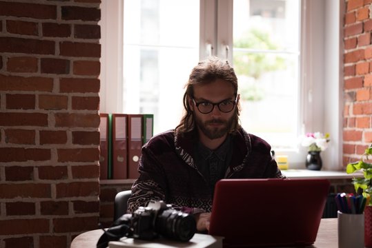 Male graphic designer working on laptop