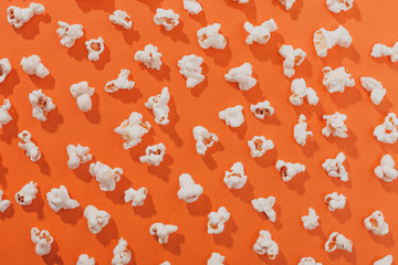 Popcorn on an orange background - obrazy, fototapety, plakaty