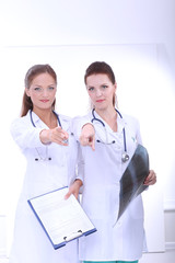 Fototapeta premium Two woman nurse watching X Ray image, standing in hospital. X Ray . Two woman doctor