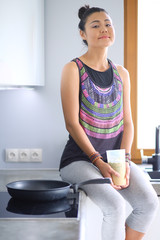 Fitness girl cooking healthy food in the kitchen. Woman. Kitchen. Cooking