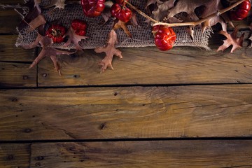 Dry leaves and mistletoe on wooden plank