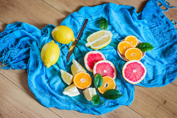 Citrus mix on blue background. Variety of citrus fruits