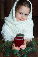 .A girl in a white knitted scarf holds a cup of cranberry mors - 183933688