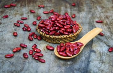 Red kidney bean on rattan cup on wooden background