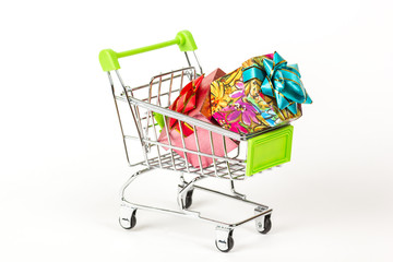 Shopping trolley full of Christmas presents. Christmassy gifts. On a white background