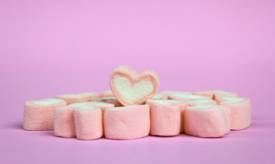 marshmallow heart shape with love concept on pink background