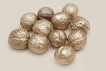 Golden Walnut Isolated. Cristmas Decoration on Warm Neutral Background.