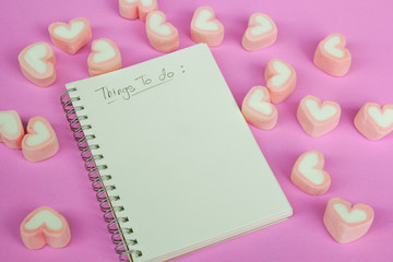 marshmallow heart shape with love concept on pink background