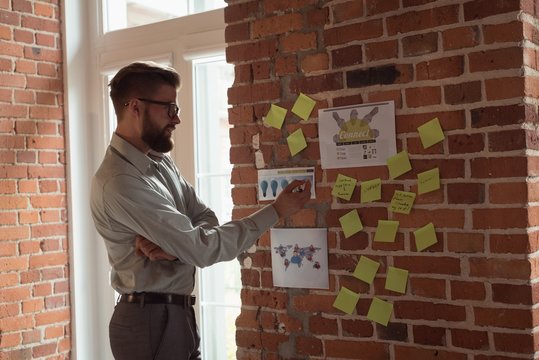 Executive looking at sticky notes
