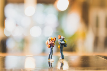 Miniature Backpacker , Tourist people standing on glass with blurred  background