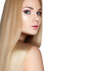 Naklejka premium Beautiful blond girl with a perfectly smooth hair, and classic make-up. Beauty face. Picture taken in the studio.