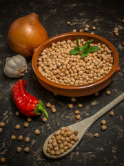 Uncooked chickpeas over stone table. Traditional spanish food ingredient, typical of Madrid