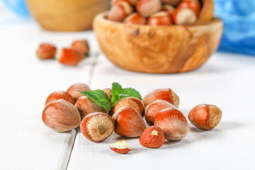 Walnut hazelnut in a bowl on a white wooden table.