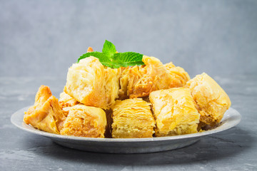 baklava turkish traditional delight on a dark wood background. toning.