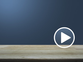 Play button on wooden table over light blue gradient background, Business music online concept