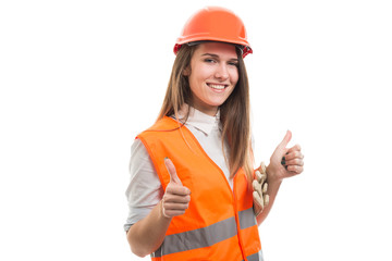 Happy professional constructor girl with both thumbs up