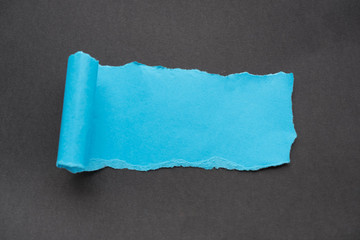 blue rip paper isolated on black background with space for text