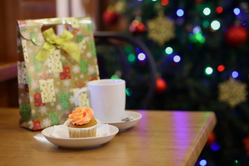coffee Cup and cake on the table near the Christmas tree