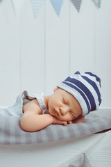 portrait of sleeping innocent infant baby in hat