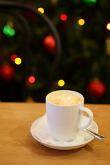 coffee Cup and cake on the table near the Christmas tree