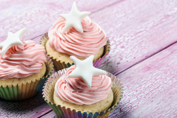 Christmas cupcakes with a star on the wooden table