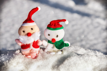 toy Santa and snowman in the snow for the holiday Christmas and new year