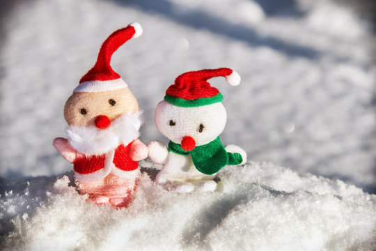toy Santa and snowman in the snow for the holiday Christmas and new year