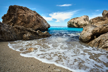 Fototapeta na wymiar Boulders on the beach on the island of Lefkada in Greece.