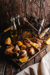tasty grilled chicken legs with slices on orange